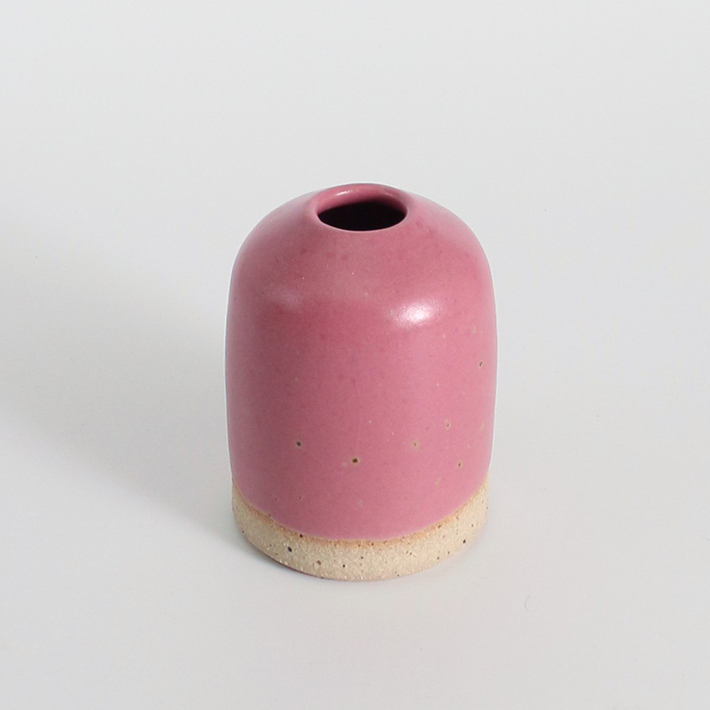 Pink ceramic vase on a light grey background