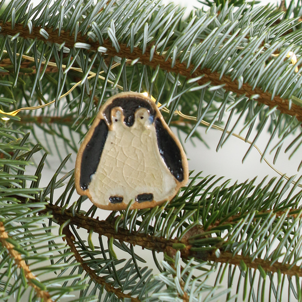 Penguin ornament on a Christmas tree branch