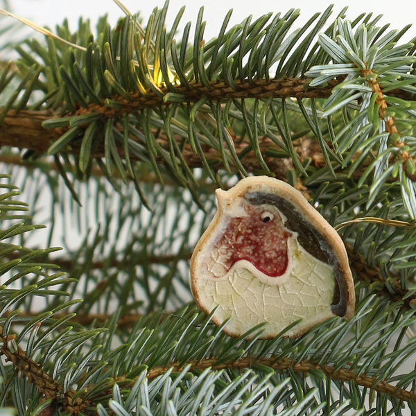 Decorative robin ornament on a Christmas tree branch
