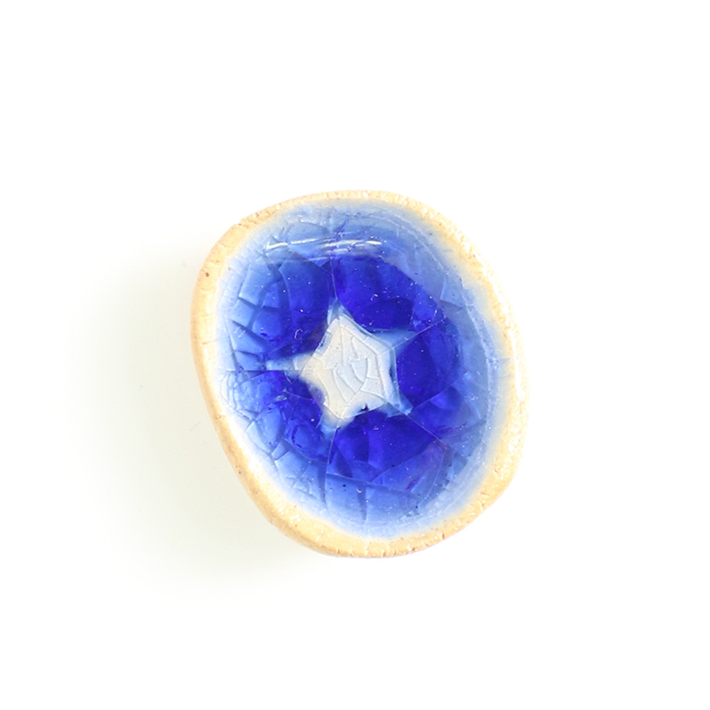 Blue ceramic stone with a star design on a white background