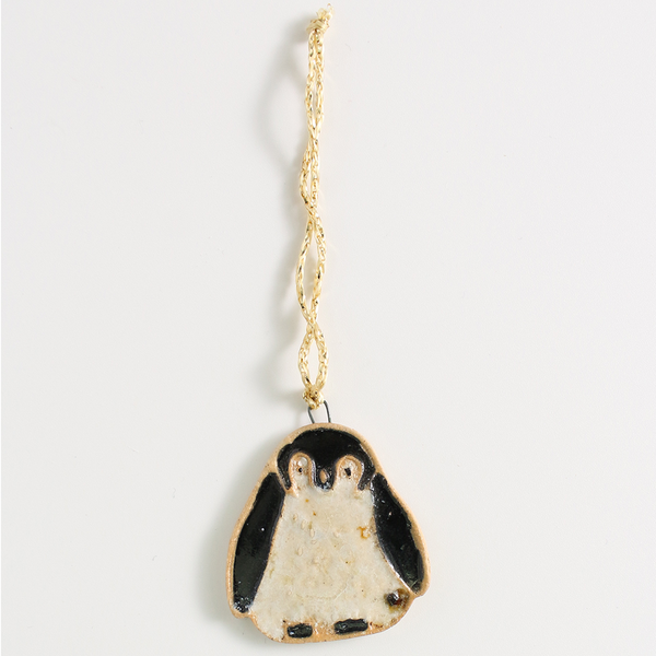 Christmas penguin decoration on a light gray background
