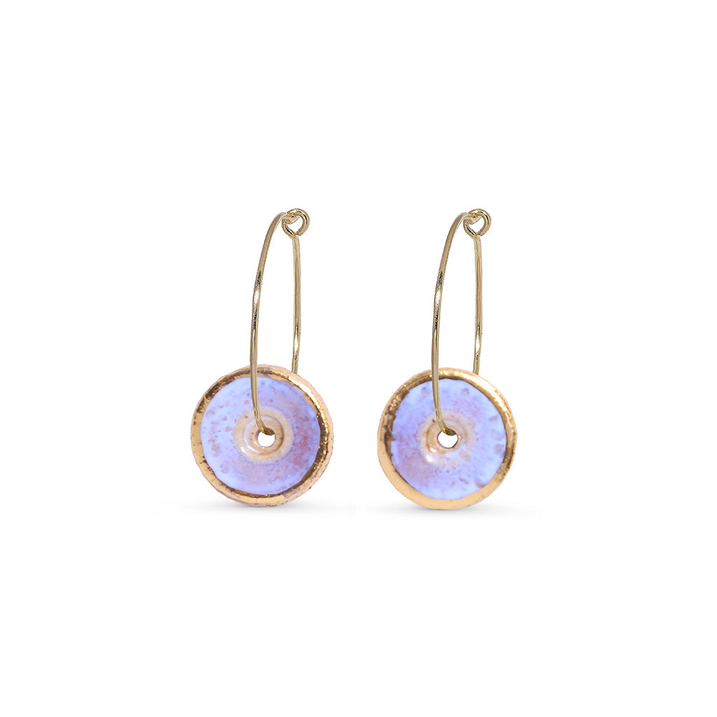 Pair of gold hoop earrings with opal circular discs on a white background