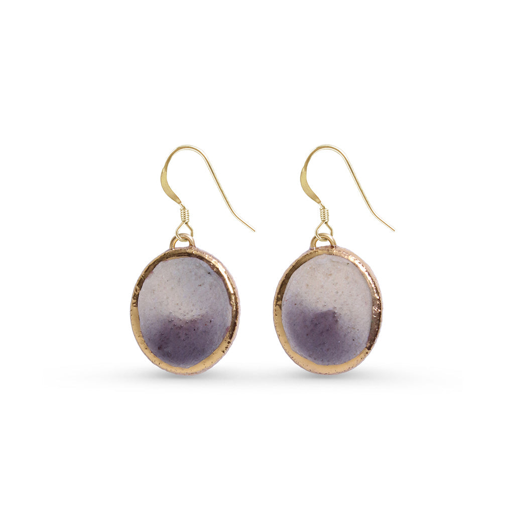 Gold-framed purple pendant earrings on a white background