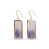 Pair of earrings with rectangular purple and gold design on a white background