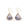 Pair of gold-framed purple stone earrings on a white background