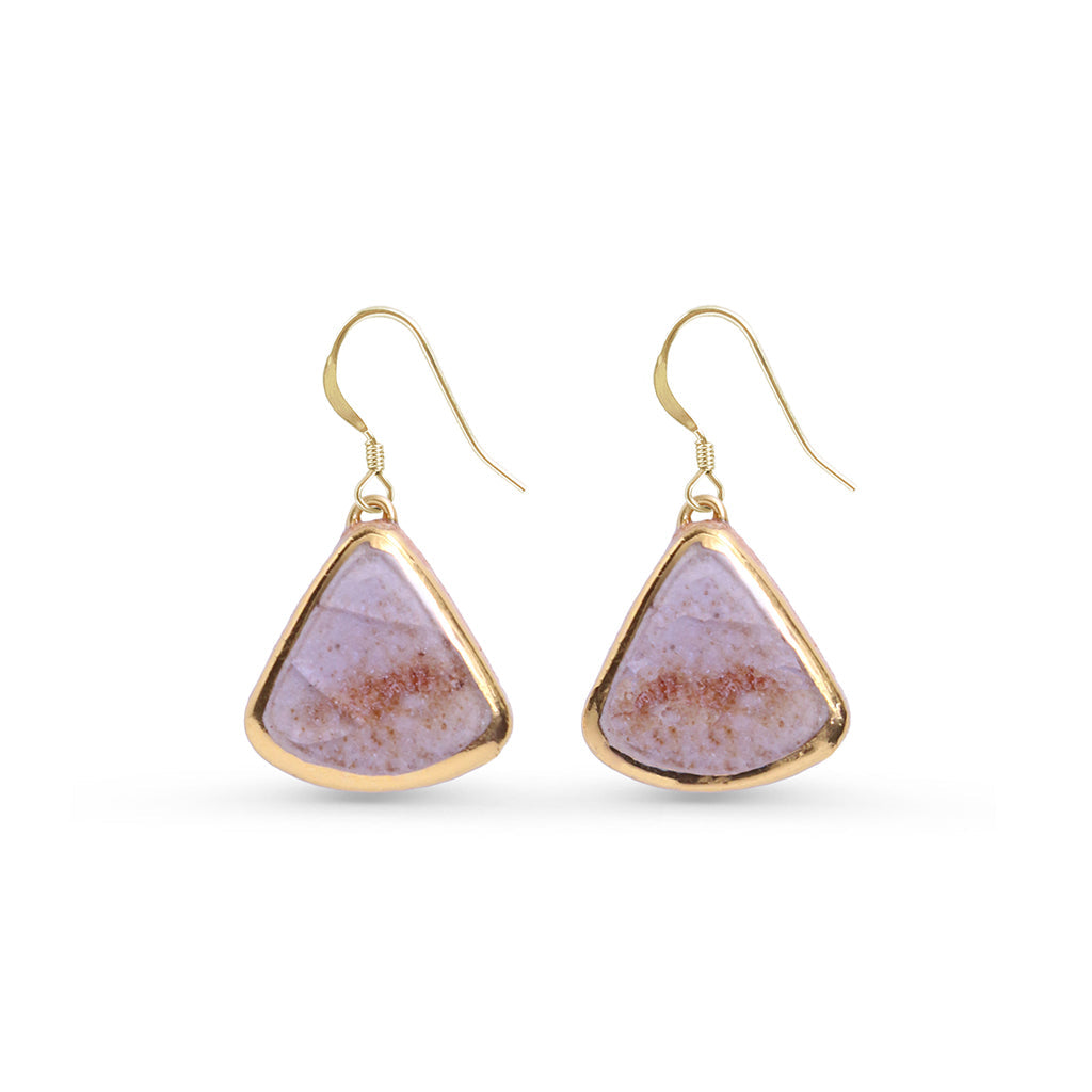 Pair of gold-trimmed earrings with pink and purple stone on a white background