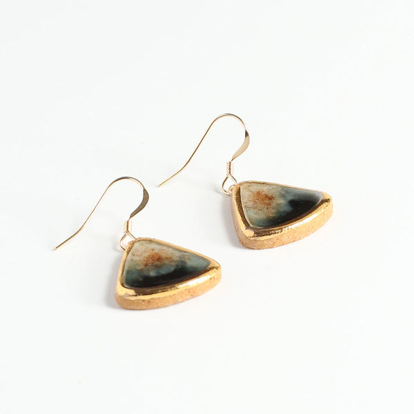 Triangular earrings with gold lustre edge and natural stone centre on a white background