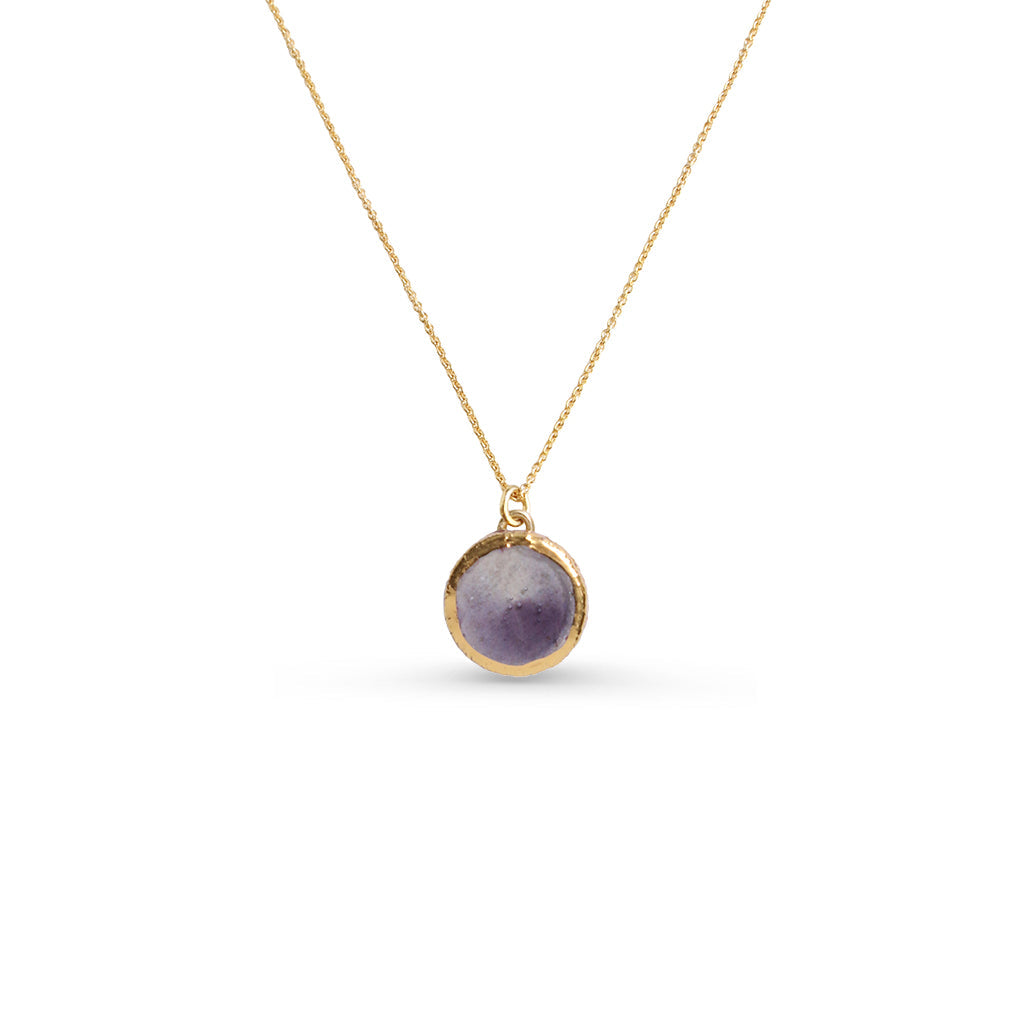 Small Dusk pendant with a gold chain against a white background. The ceramic pendant features smoky purple glass and gold lustre detailing around the edge of the pendant. 