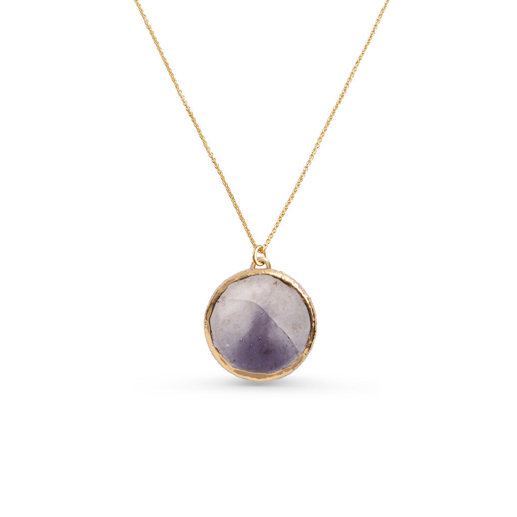 Necklace with a round purple pendant on a gold chain against a white background