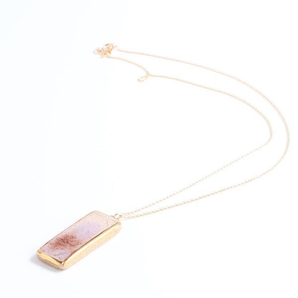 Necklace with a rectangular elements inspired pendant on a white background